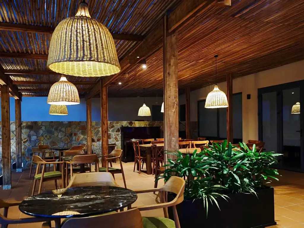 Warmly lit dining and lounge area at Field Villa Hoàng Diệu